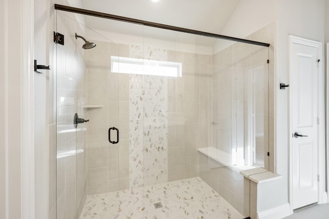 bathroom featuring lofted ceiling and an enclosed shower