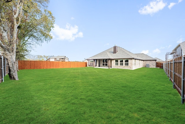 rear view of property with a lawn