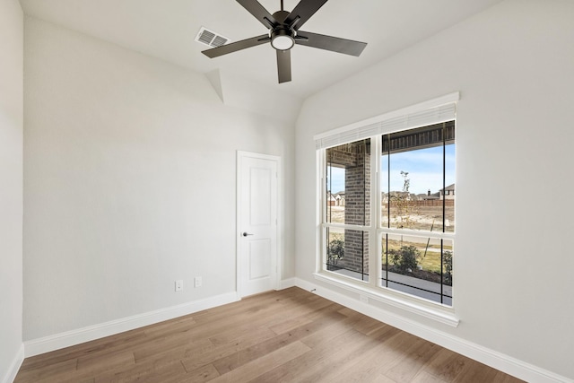 spare room with light hardwood / wood-style floors, ceiling fan, and lofted ceiling