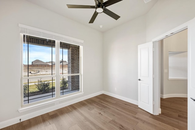 empty room with hardwood / wood-style flooring and ceiling fan