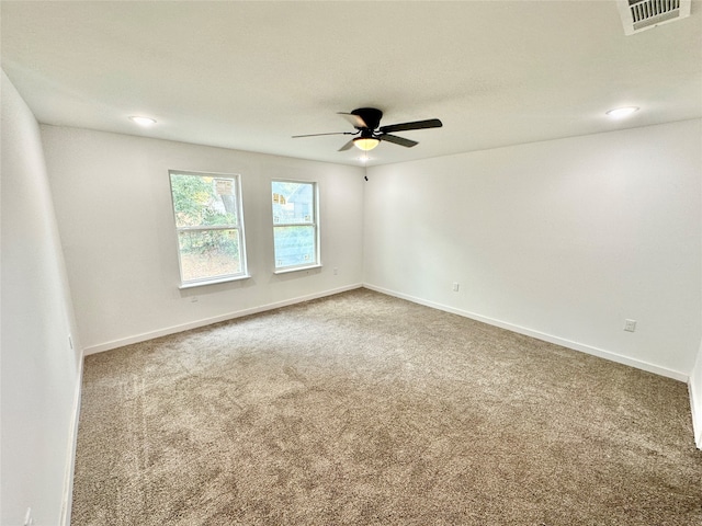 spare room featuring carpet flooring and ceiling fan