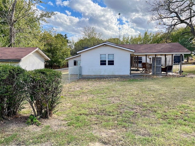 back of house featuring a patio and a lawn