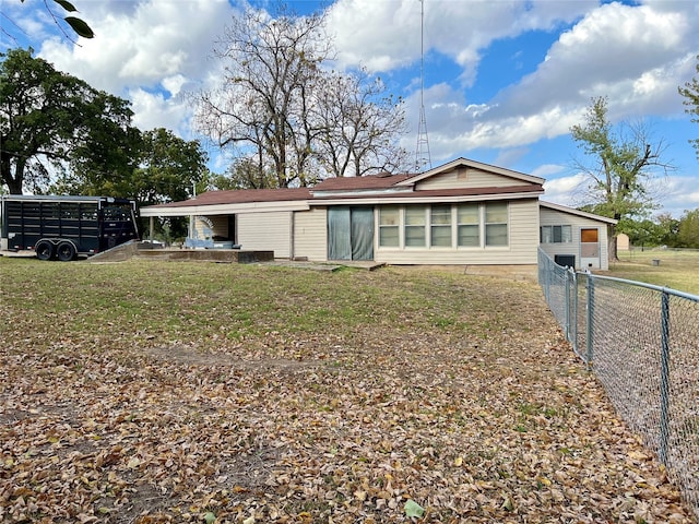 rear view of property with a lawn