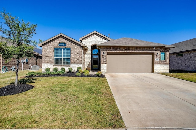 view of front of property with a garage, a front yard, and central AC