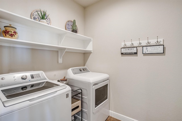 clothes washing area with washing machine and dryer