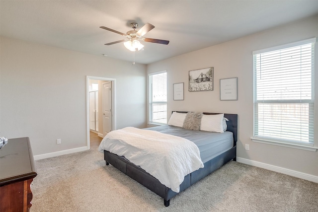 carpeted bedroom with multiple windows and ceiling fan