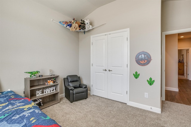 carpeted bedroom featuring lofted ceiling and a closet