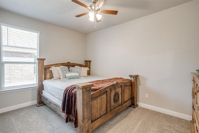 carpeted bedroom featuring multiple windows and ceiling fan