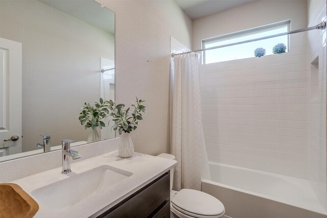 full bathroom with shower / bath combination with curtain, toilet, and vanity