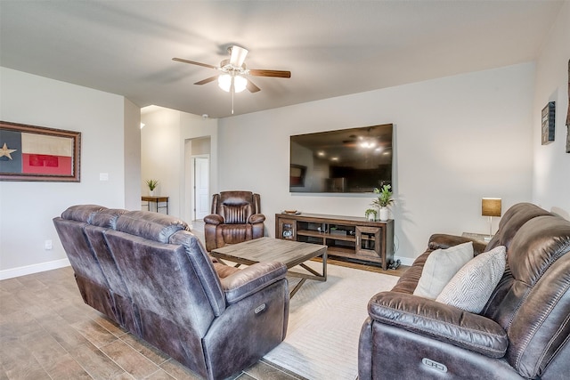 living room with ceiling fan and light hardwood / wood-style floors