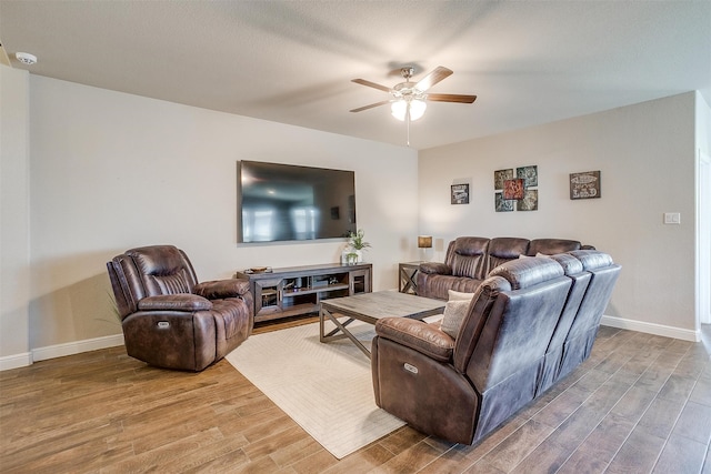 living room featuring hardwood / wood-style flooring and ceiling fan