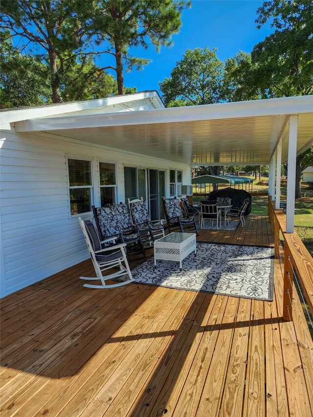 wooden terrace featuring a water view