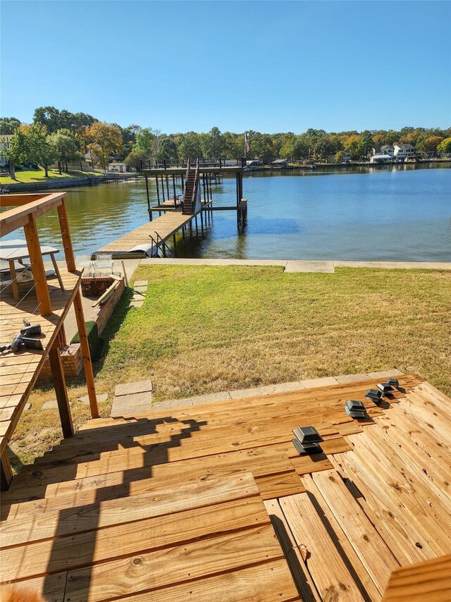 dock area with a patio, a fire pit, and a water view