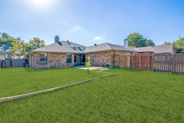 rear view of property with a patio area and a lawn