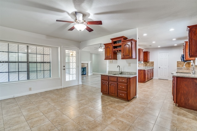 kitchen with tasteful backsplash, sink, and light stone counters