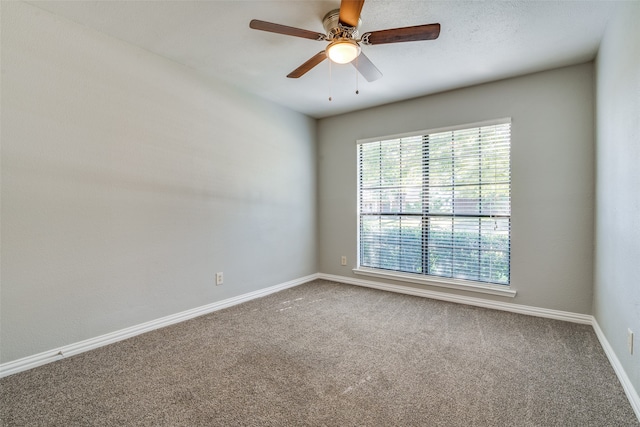 carpeted empty room featuring ceiling fan