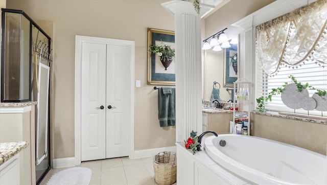 bathroom with vanity, plus walk in shower, ornate columns, and tile patterned flooring