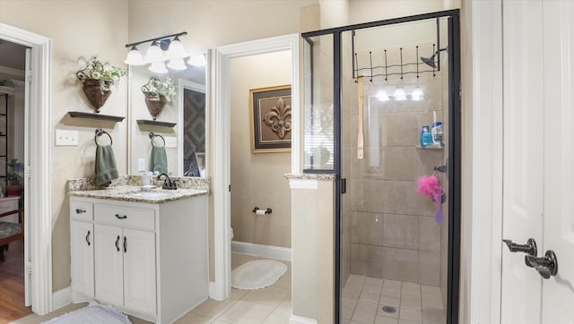 bathroom with vanity, tile patterned floors, toilet, and walk in shower