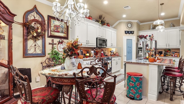 kitchen featuring white cabinets, stainless steel appliances, hanging light fixtures, and a kitchen island