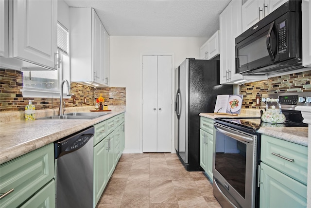 kitchen with sink, green cabinets, appliances with stainless steel finishes, a textured ceiling, and white cabinets