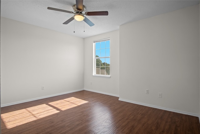 spare room with a textured ceiling, wood finished floors, baseboards, and ceiling fan