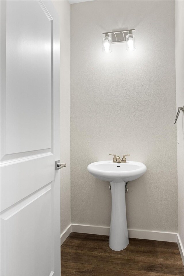 bathroom with hardwood / wood-style floors