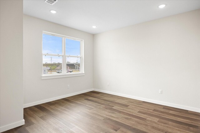 spare room with dark wood-type flooring