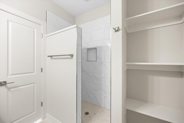 bathroom with tiled shower