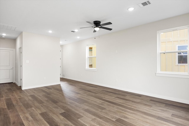 spare room with ceiling fan and dark wood-type flooring