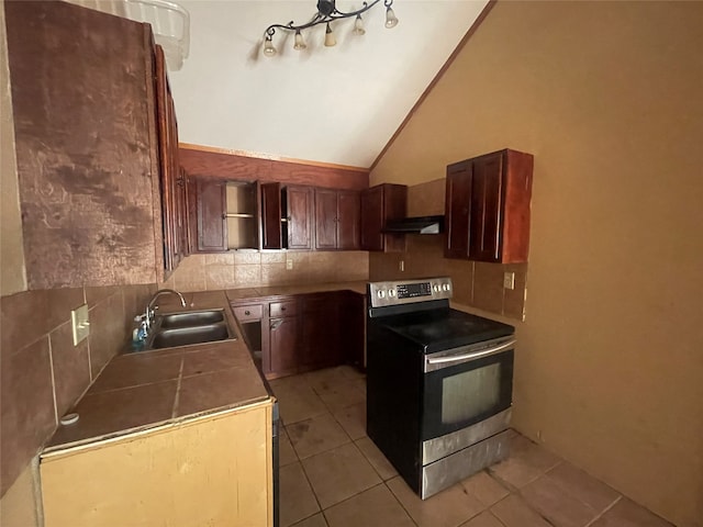 kitchen featuring sink, backsplash, stainless steel electric range oven, high vaulted ceiling, and light tile patterned floors