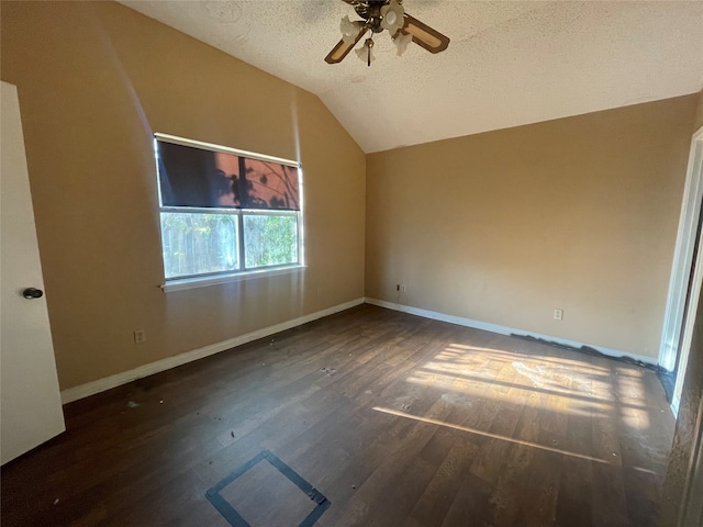 unfurnished room featuring lofted ceiling, dark hardwood / wood-style floors, a textured ceiling, and ceiling fan