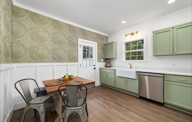 kitchen with green cabinets, sink, stainless steel dishwasher, and dark wood-type flooring