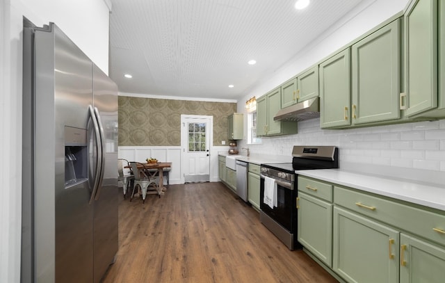 kitchen featuring dark hardwood / wood-style floors, crown molding, appliances with stainless steel finishes, and green cabinetry