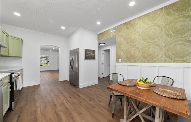 dining area with crown molding and dark wood-type flooring