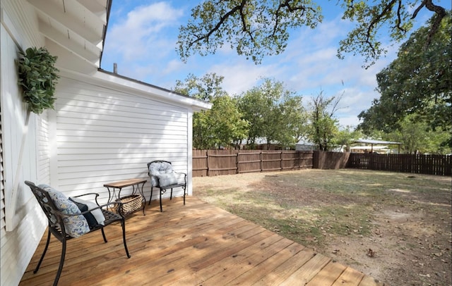 wooden deck featuring a yard