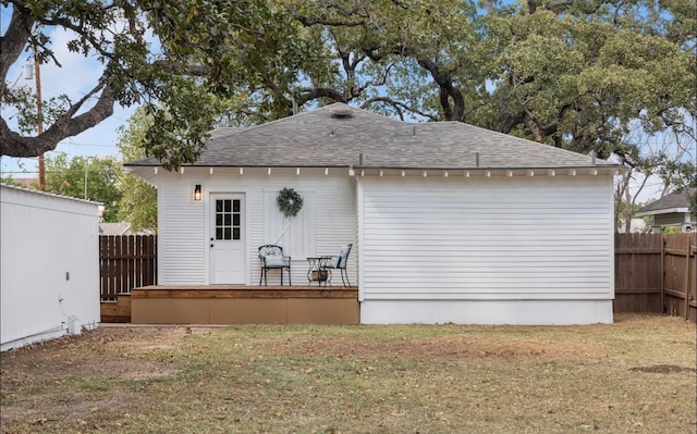 back of property featuring a yard