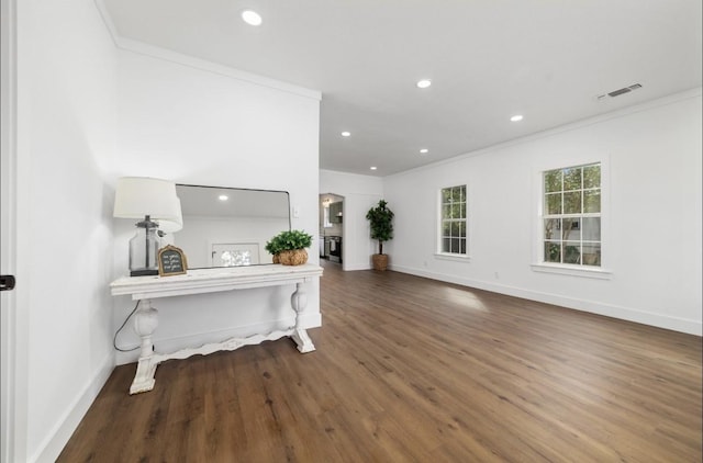 foyer entrance with crown molding and hardwood / wood-style flooring