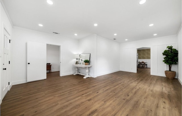 interior space with dark hardwood / wood-style floors and ornamental molding