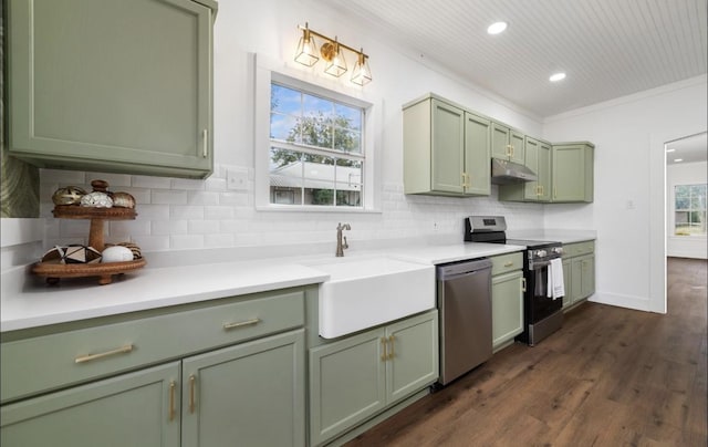 kitchen with backsplash, green cabinets, sink, and stainless steel appliances