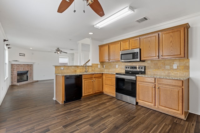 kitchen featuring sink, stainless steel appliances, a brick fireplace, dark hardwood / wood-style flooring, and ornamental molding