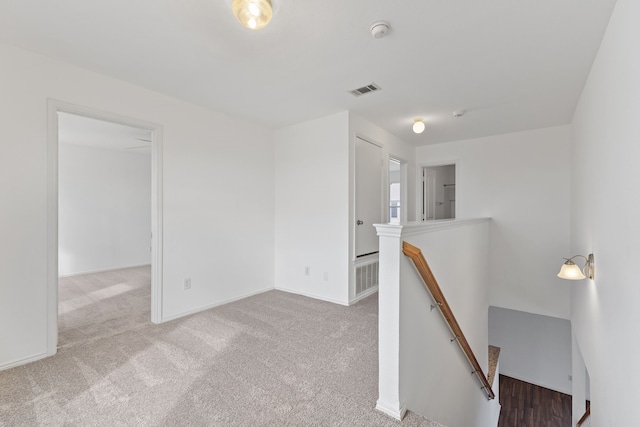 empty room with light carpet, a wealth of natural light, and ceiling fan