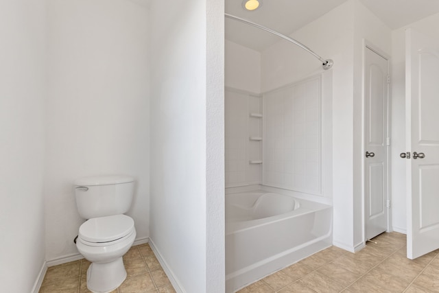 bathroom featuring washtub / shower combination, tile patterned floors, and toilet