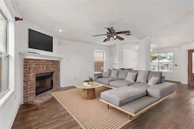 unfurnished living room featuring ceiling fan, a healthy amount of sunlight, dark hardwood / wood-style floors, and ornamental molding