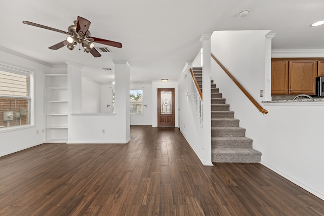 foyer featuring dark hardwood / wood-style floors, ceiling fan, and ornamental molding