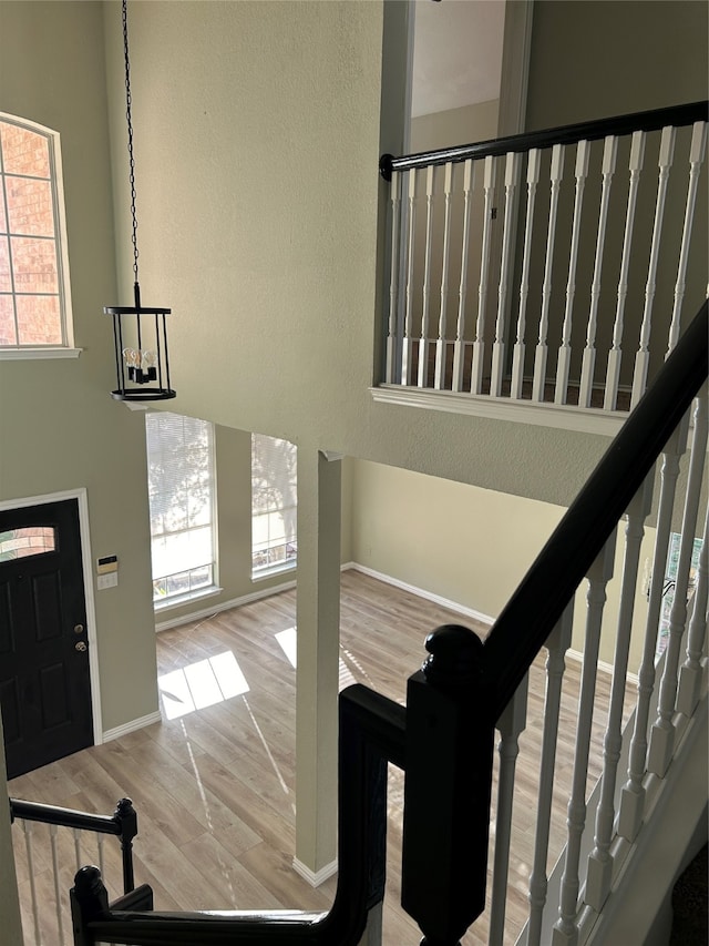 entrance foyer featuring wood-type flooring and an inviting chandelier