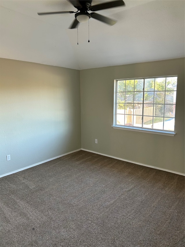 spare room with ceiling fan, carpet, and vaulted ceiling