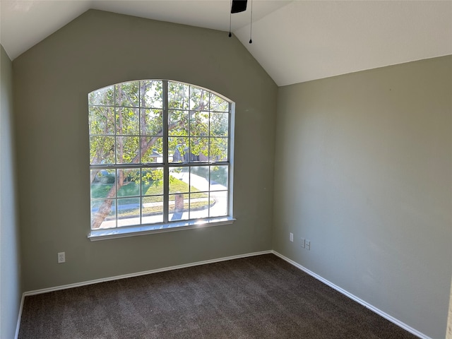 carpeted spare room with vaulted ceiling and ceiling fan