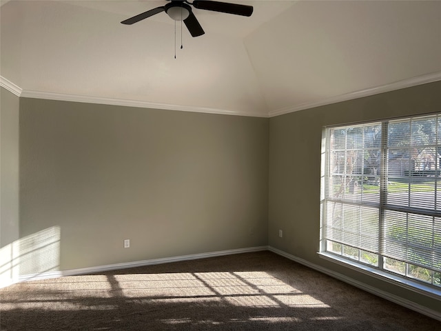 carpeted empty room featuring lofted ceiling, ornamental molding, and ceiling fan