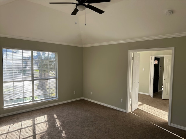 carpeted spare room featuring ornamental molding, vaulted ceiling, a healthy amount of sunlight, and ceiling fan