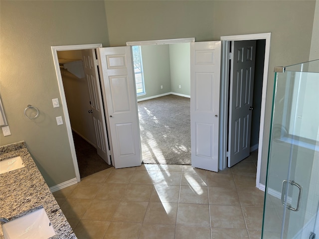 bathroom featuring vanity, an enclosed shower, and tile patterned flooring